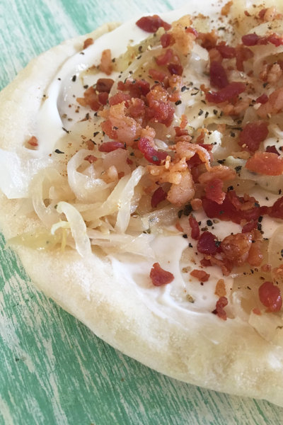 tarte flambee french pizza camp topisaw bacon caramelized onions